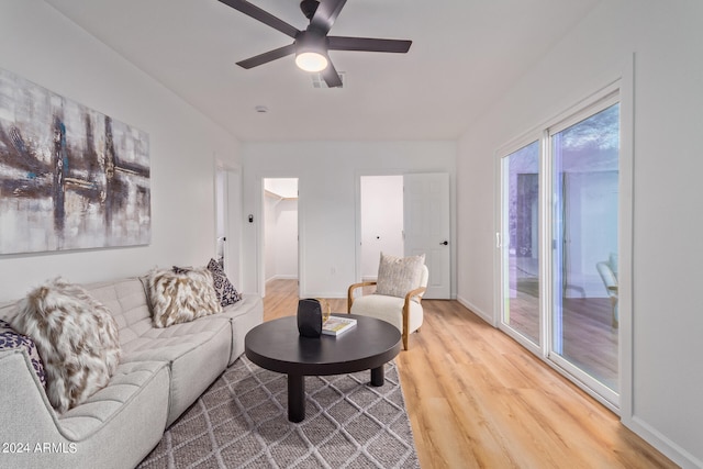 living room with light wood-type flooring and ceiling fan