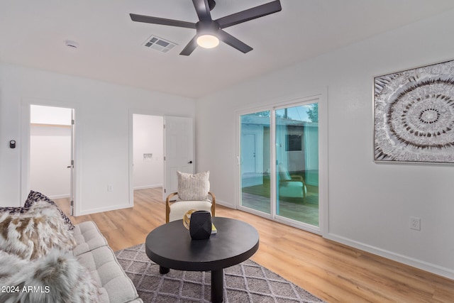 living room featuring light wood-type flooring and ceiling fan