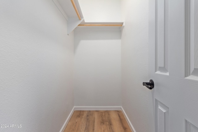 spacious closet with light hardwood / wood-style flooring