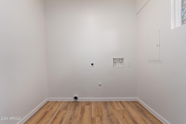 clothes washing area featuring hookup for a washing machine, hookup for a gas dryer, light hardwood / wood-style flooring, electric panel, and hookup for an electric dryer