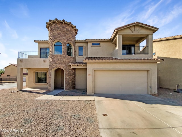 mediterranean / spanish house featuring stucco siding, a balcony, and an attached garage