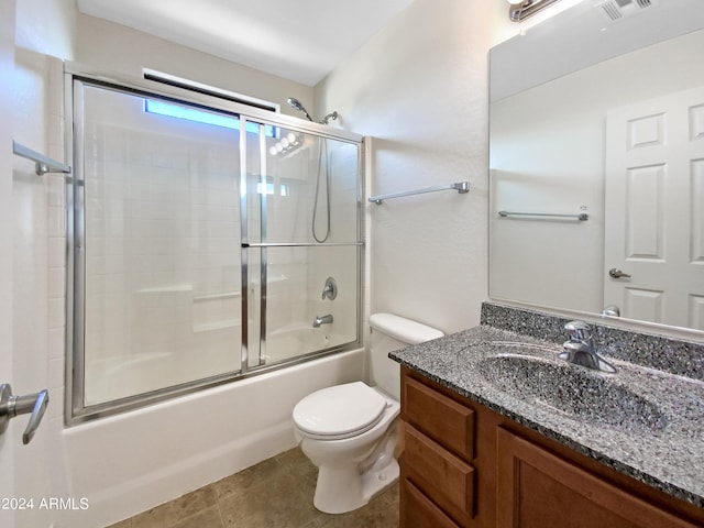 full bathroom with tile patterned floors, visible vents, toilet, bath / shower combo with glass door, and vanity