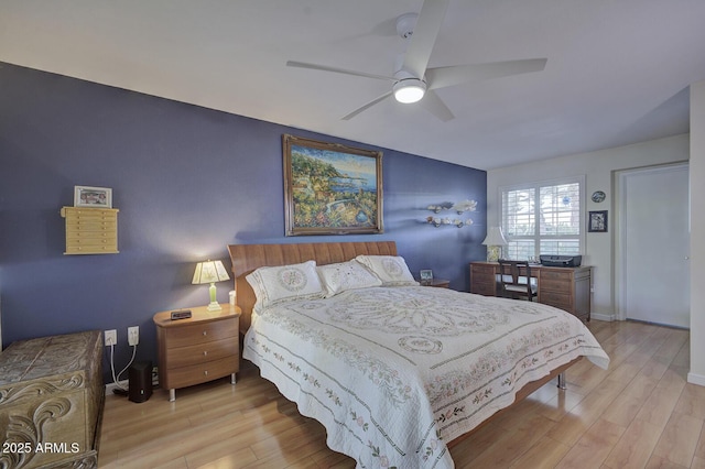 bedroom with ceiling fan and light hardwood / wood-style floors