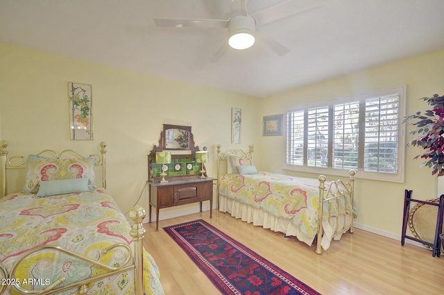 bedroom with ceiling fan and light hardwood / wood-style flooring