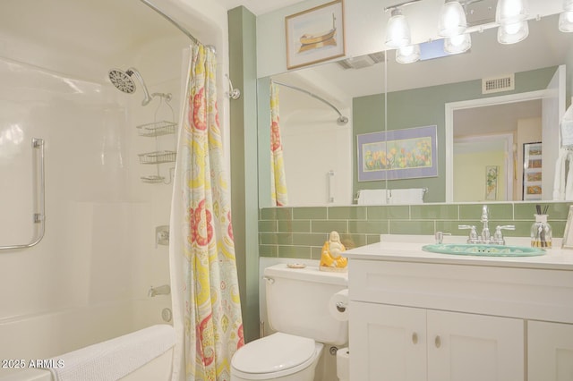 full bathroom with toilet, vanity, backsplash, and shower / bath combo