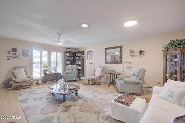 living room with ceiling fan and light hardwood / wood-style floors