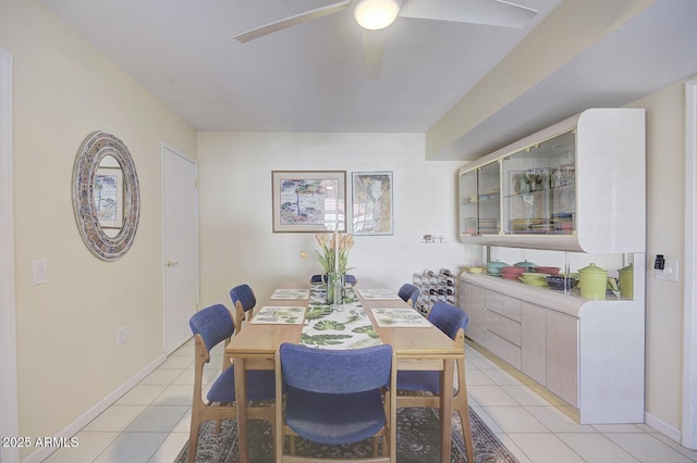 dining space with ceiling fan and light tile patterned floors