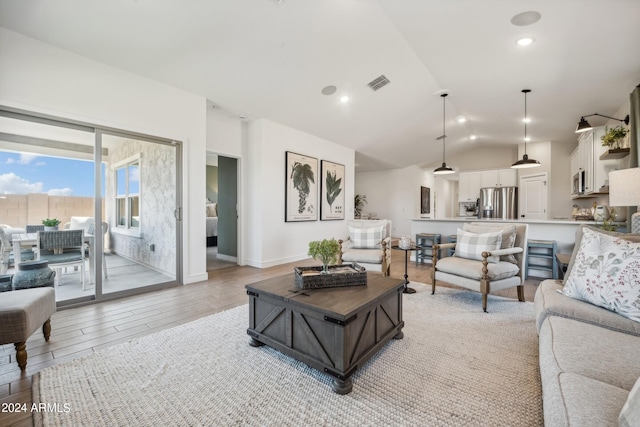 living room featuring light wood-type flooring and lofted ceiling