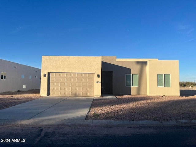 pueblo-style home featuring a garage