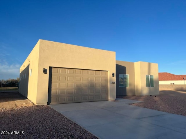 pueblo revival-style home with a garage