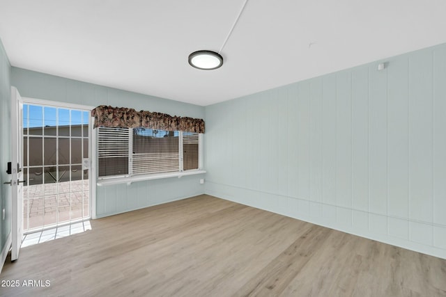 unfurnished room with wood finished floors