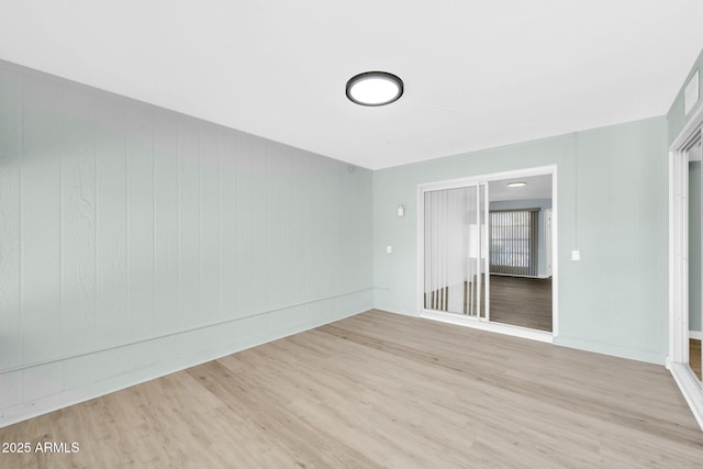 unfurnished room with wood finished floors