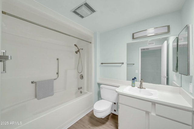 full bath with visible vents, toilet, wood finished floors, vanity, and  shower combination