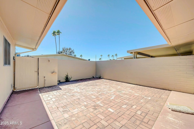 view of patio / terrace featuring a gate and fence
