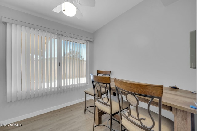dining area featuring baseboards, wood finished floors, ceiling fan, and vaulted ceiling