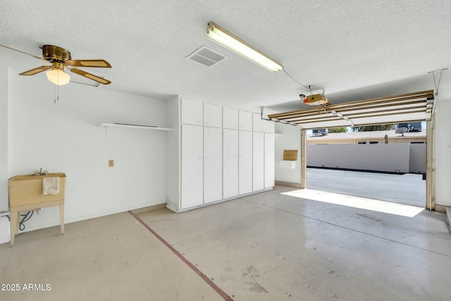garage featuring visible vents and a garage door opener