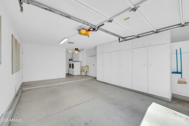 garage featuring a sink and washing machine and clothes dryer