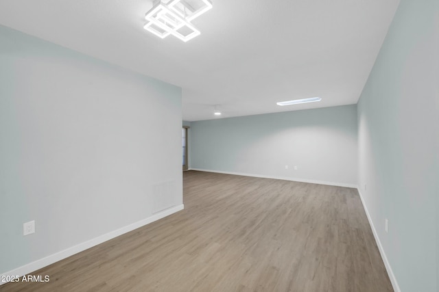 unfurnished room featuring wood finished floors and baseboards