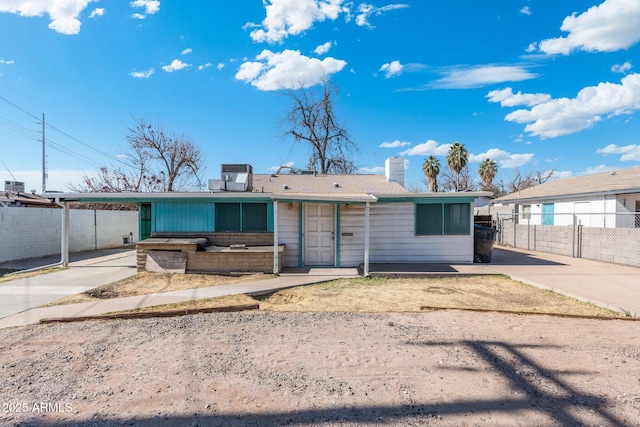 view of front of house with a carport and central air condition unit