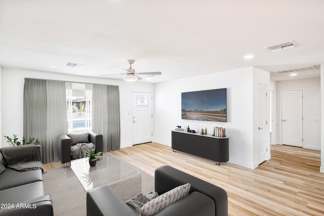 living room with ceiling fan and light wood-type flooring