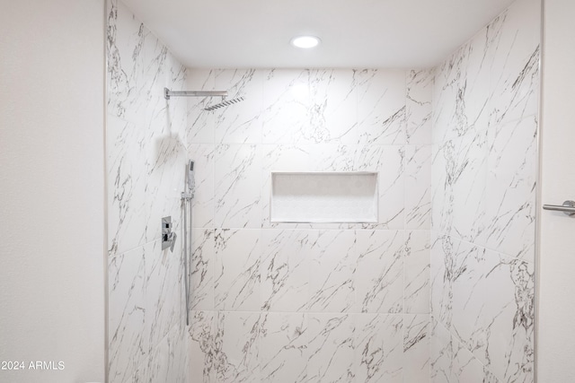 interior details featuring tiled shower