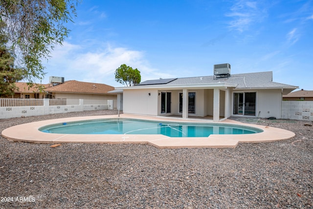 view of swimming pool with cooling unit and a patio area