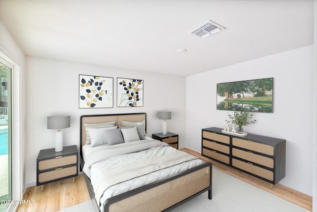 bedroom with hardwood / wood-style floors