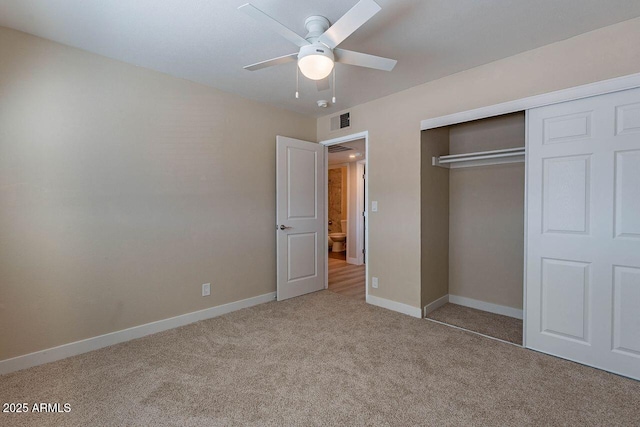 unfurnished bedroom with a closet, baseboards, visible vents, and carpet floors