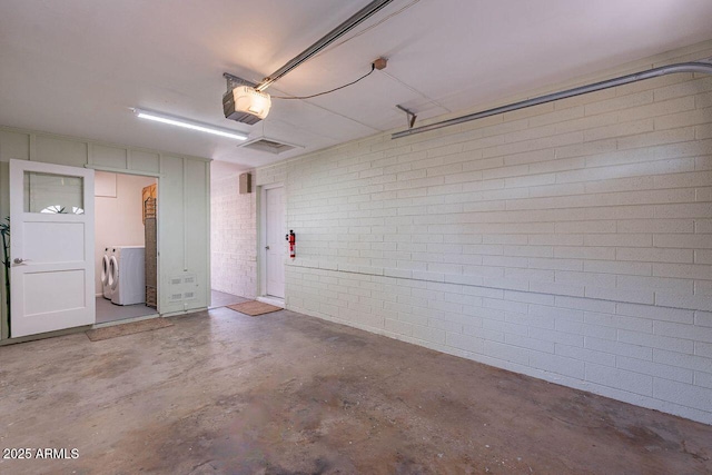 garage featuring washer / clothes dryer and a garage door opener