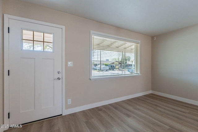 entryway featuring baseboards and wood finished floors