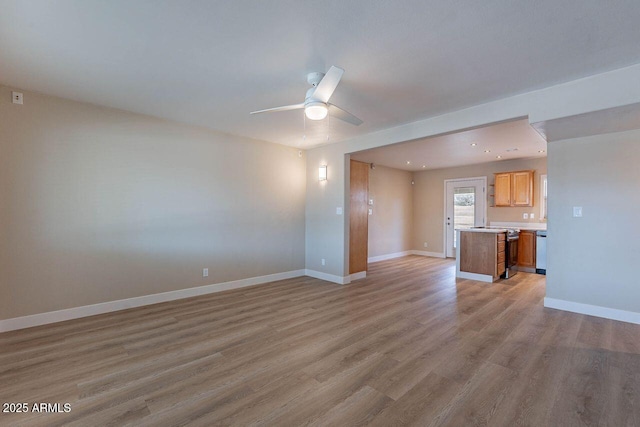 unfurnished living room featuring recessed lighting, a ceiling fan, light wood-type flooring, and baseboards