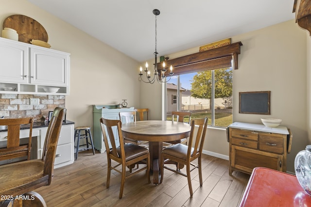 dining room with a notable chandelier and dark hardwood / wood-style flooring