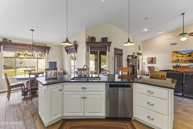 kitchen with white cabinetry, sink, an island with sink, and dishwasher