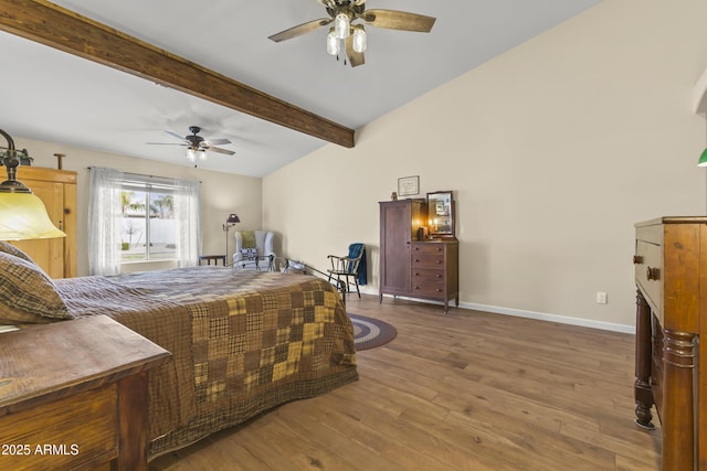 bedroom with hardwood / wood-style flooring, ceiling fan, and vaulted ceiling with beams