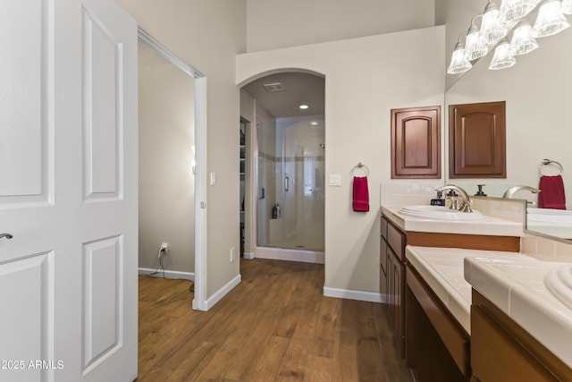 bathroom featuring vanity, a shower with shower door, and hardwood / wood-style floors