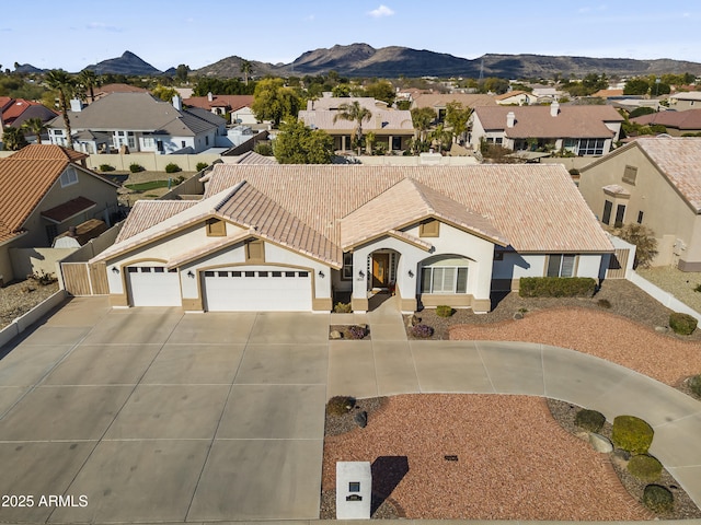 view of front of property featuring a garage and a mountain view