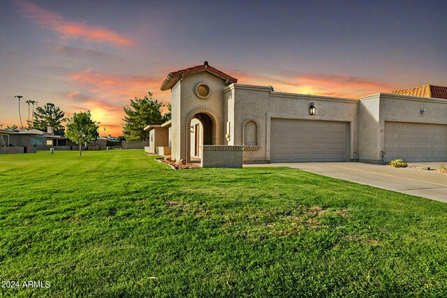 view of front facade with a lawn and a garage