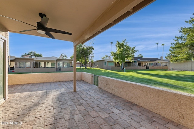 view of patio featuring a ceiling fan and a residential view