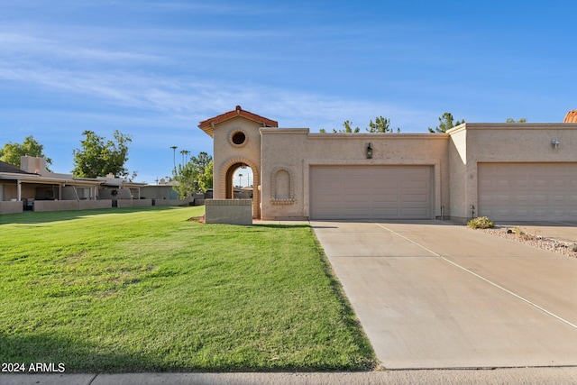 view of front of home featuring a garage, stucco siding, driveway, and a front lawn