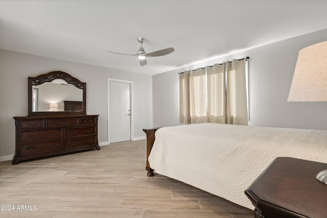 bedroom with light wood-type flooring and ceiling fan