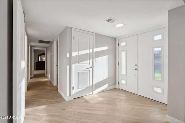 entrance foyer featuring visible vents, baseboards, and light wood-style floors
