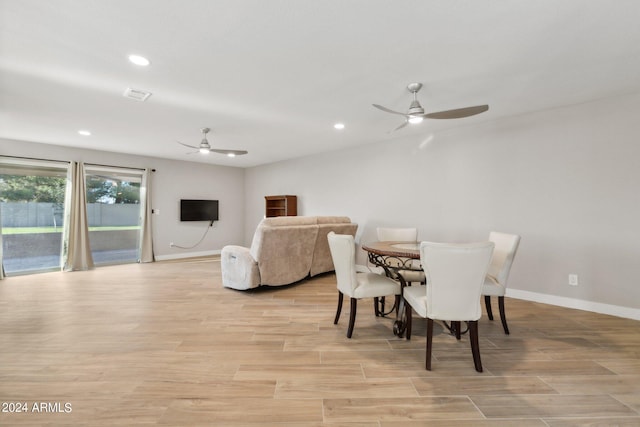 dining area with ceiling fan and light wood-type flooring