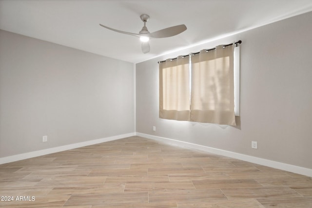 unfurnished room featuring light hardwood / wood-style flooring and ceiling fan