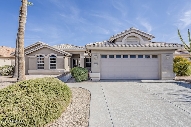 15411 W Amelia Dr, Goodyear, AZ 85395 - view of front of house with driveway, an attached garage, stucco siding, and a tiled roof