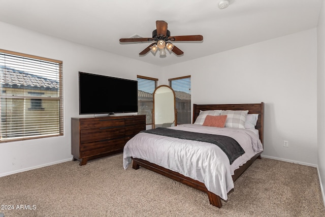 bedroom featuring light colored carpet and ceiling fan