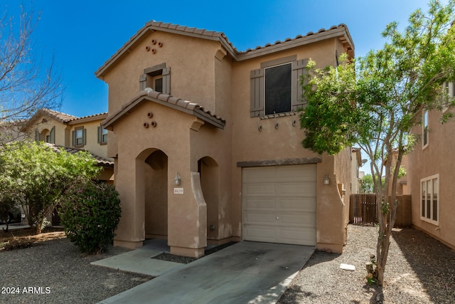 mediterranean / spanish-style home with a garage