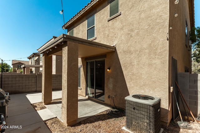 rear view of house with a patio and central AC unit