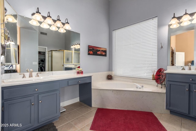 6531 E Star Valley St, Mesa, AZ 85215 - bathroom with visible vents, two vanities, a garden tub, tile patterned flooring, and a sink