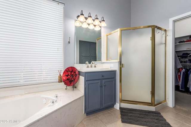 6531 E Star Valley St, Mesa, AZ 85215 - bathroom featuring tile patterned flooring, vanity, a spacious closet, a bath, and a stall shower