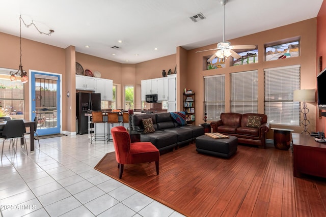 6531 E Star Valley St, Mesa, AZ 85215 - living area with visible vents, ceiling fan with notable chandelier, a towering ceiling, and recessed lighting